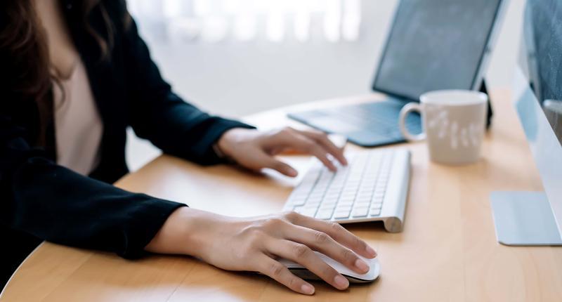 Close up of woman hand using computer mouse at the office