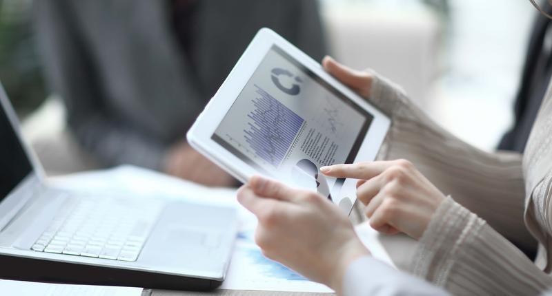 close up.the business team uses a digital tablet to verify financial data