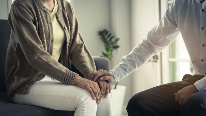 mental health treatment concept. Stressed asian patient talking with personal psychologist in therapist session have a and doctor touching her hand feel empathy