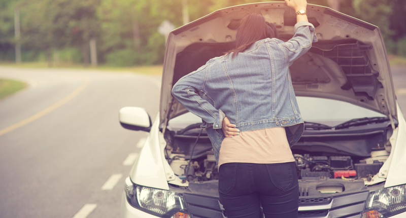 women spection she opened the hood broken car on the side