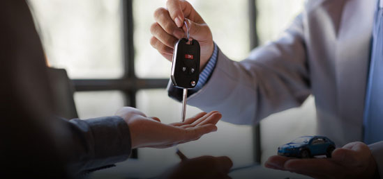 person handing keys over to another person