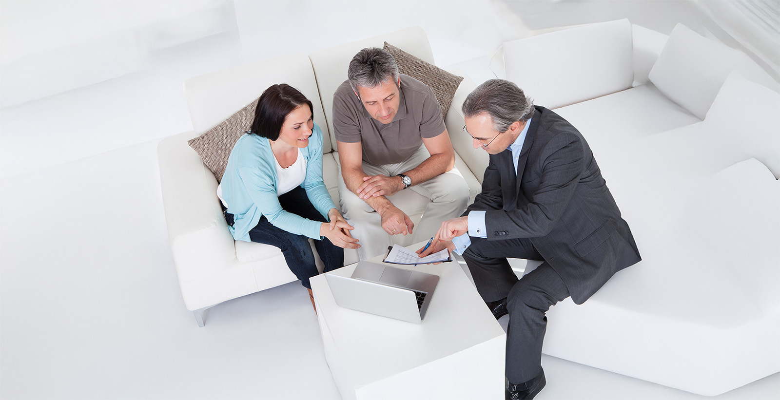 Happy Couple And Mature Consultant Discussing Together